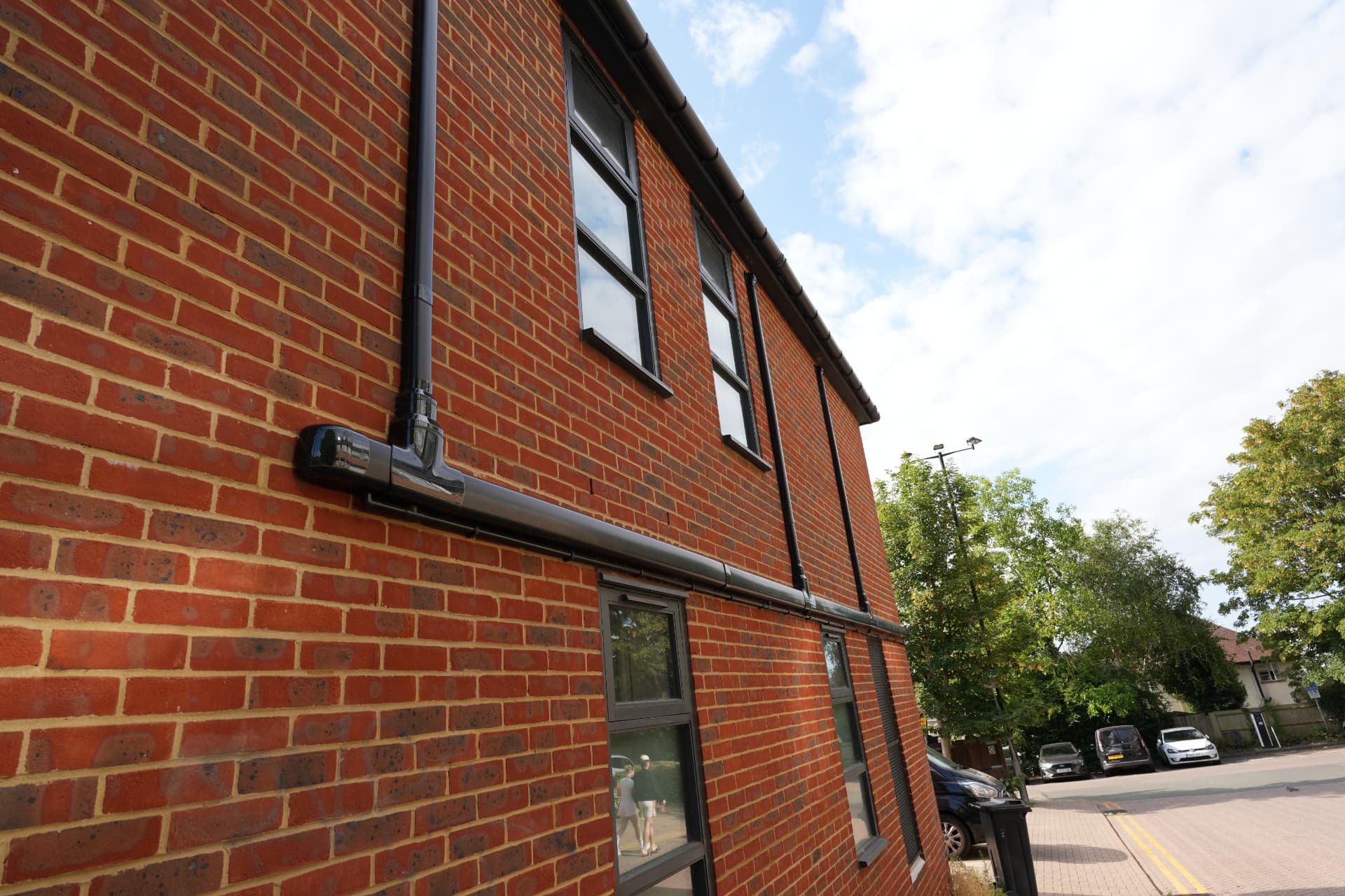 Neatly routed external air conditioning pipework on the Youth Talk building