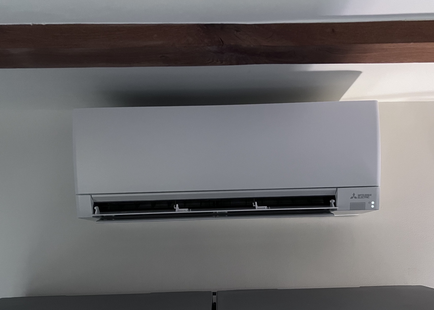 Mitsubishi Electric 2.5kW wall-mounted indoor air conditioning unit installed below a beam